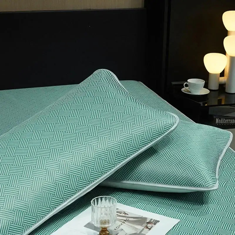 Teal woven-patterned pillow sham with light-colored piping complements silky soft cooling fitted sheet set bedding