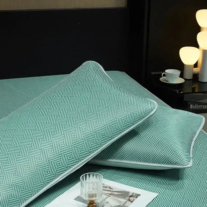 Teal woven-patterned pillow sham with light-colored piping complements silky soft cooling fitted sheet set bedding