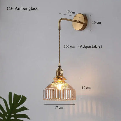 Amber glass shade led wall lamp with vertical ridges and brass-finished chain for luxury living room decor