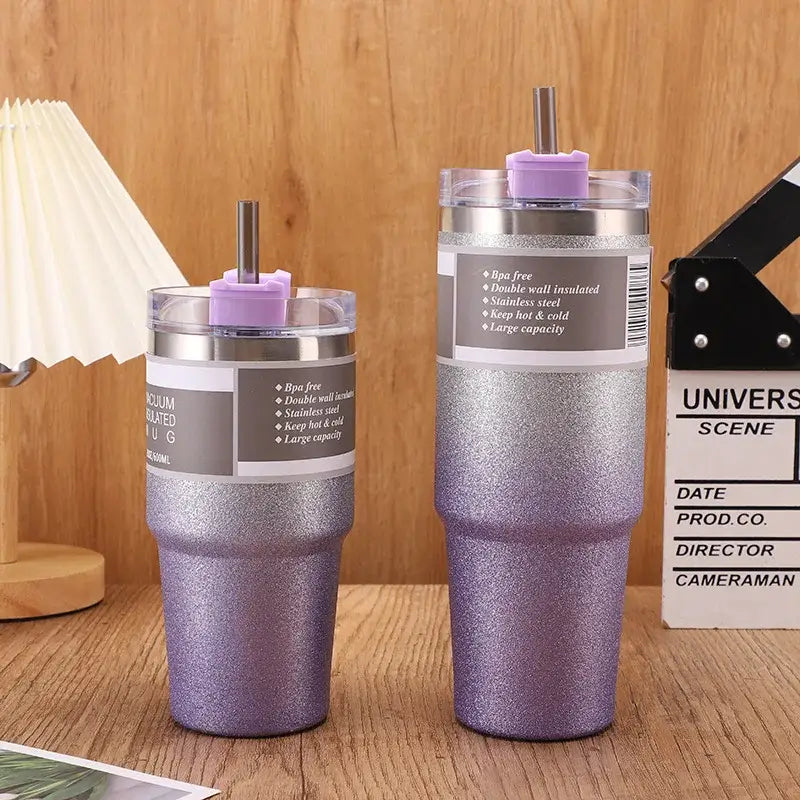 Two glittery purple decorbites coffee cup thermos tumblers with stainless steel and lavender sip straws for insulated use