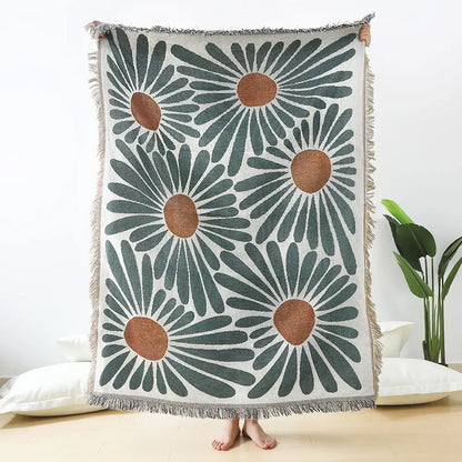 Cozy cream-colored throw blanket with bold teal and tan daisy pattern woven and soft fringed edges for decorbites decor