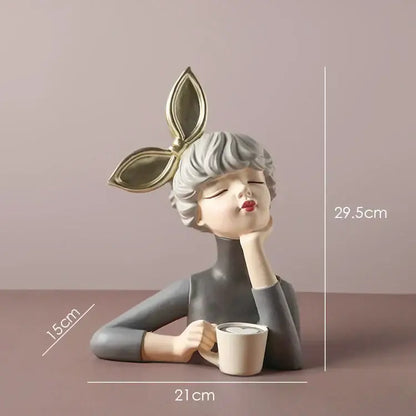 A sleek gray bowknot girl resin figurine with silver hair and gold leaf headpiece holding a white mug on gold tray decorbites bowknot girl