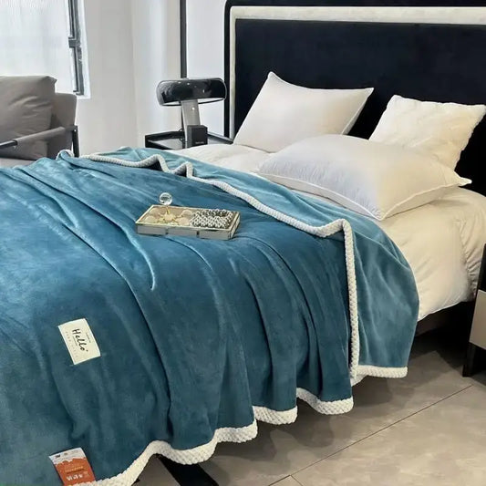 Teal plush throw blanket with white braided trim made of cozy flannel for comfortable flannel nap blanket use
