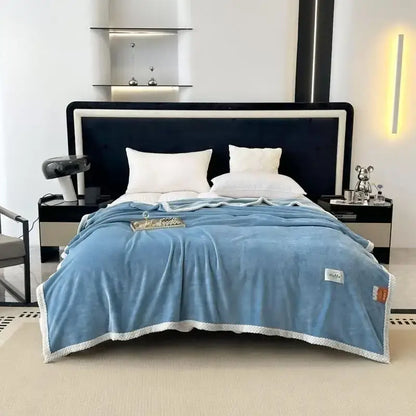 Teal and white cozy flannel nap blanket featuring a soft light blue plush throw with a white textured border and stitching details