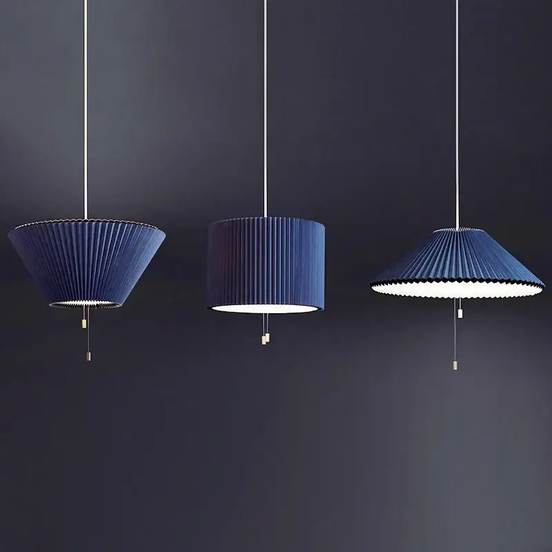 Three elegant navy blue pleated pendant lamps with decorbites deformed fabric umbrella design and metallic pull chains