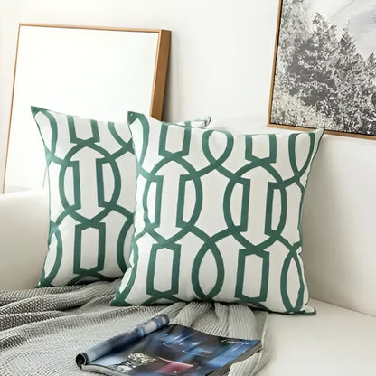 Teal and white embroidered geometric floral cushion cover with green and white geometric patterned throw pillows for living room
