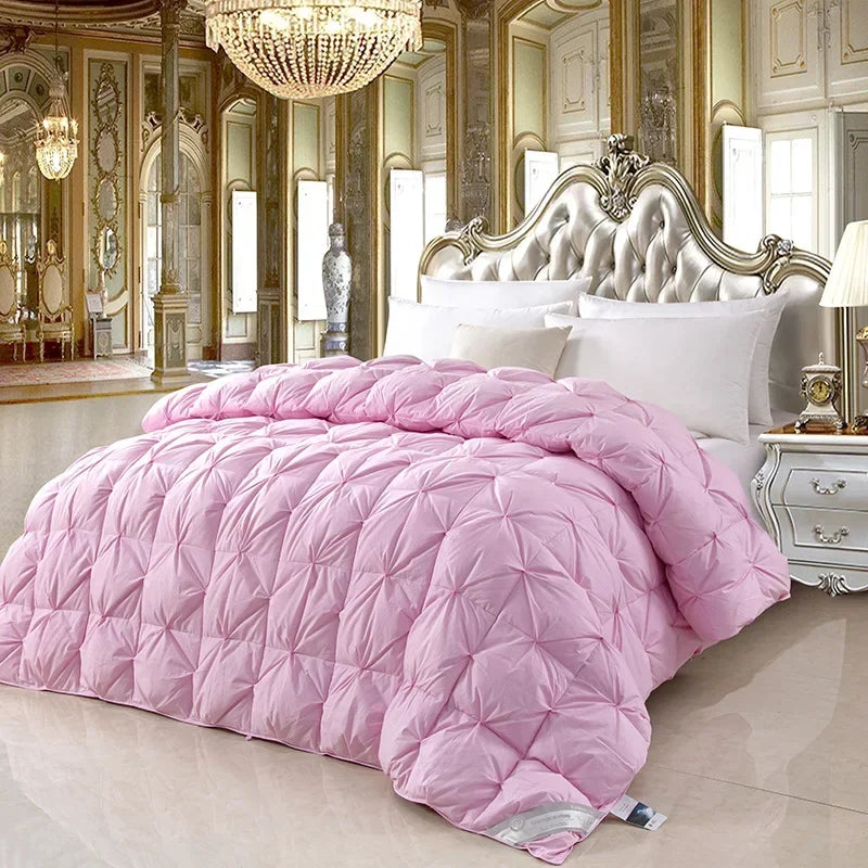 Pink quilted comforter with diamond-stitched design featuring temperature controlled white goose down for warmth and comfort