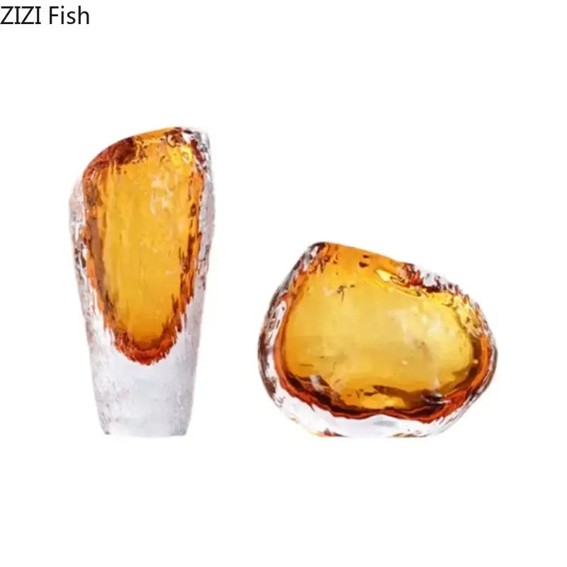 Two amber glass fish figurines with textured, translucent bodies complement decorbites amber glass vase decor