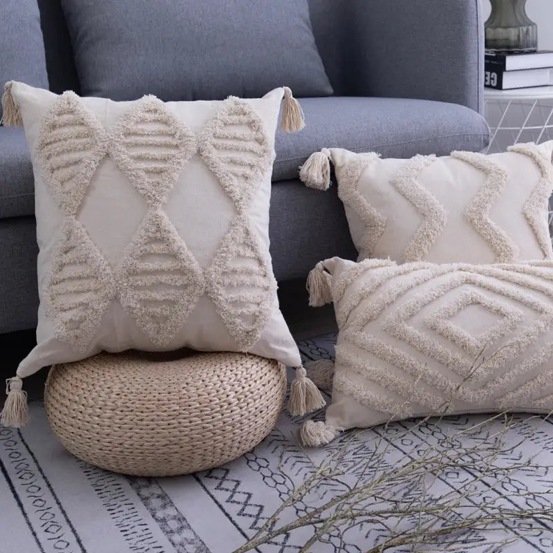 Cream-colored cushion cover with textured geometric patterns and decorbites beige tassels for living room decor
