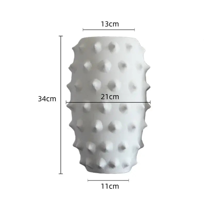 A tall white ceramic flower vase with a textured surface featuring raised bumps for decorbites black ceramic decor
