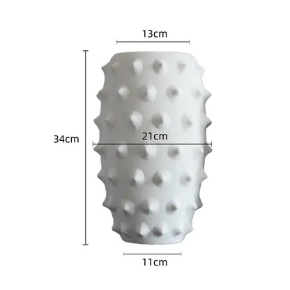 A tall white ceramic flower vase with a textured surface featuring raised bumps for decorbites black ceramic decor