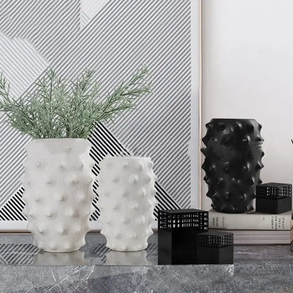 White ceramic flower vase with textured bumpy surface and greenery for decorbites black ceramic living room decor