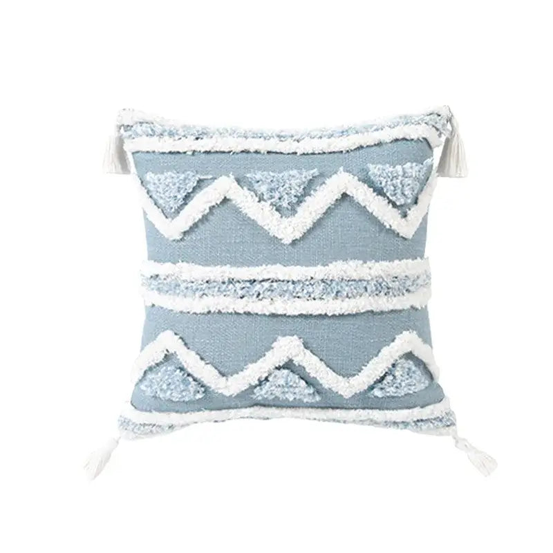 Light blue cushion cover with white textured zigzag and triangular patterns and tassels for decorbites blue geometric decor