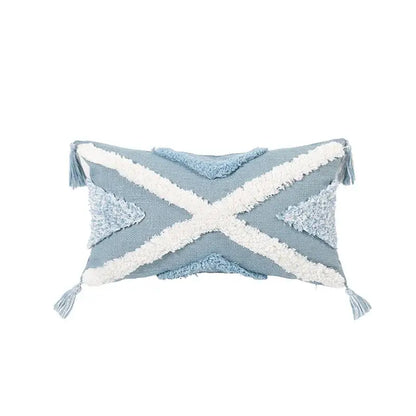 Light blue woven cushion cover with white cross accents and tassels perfect for decorbites blue geometric living room decor