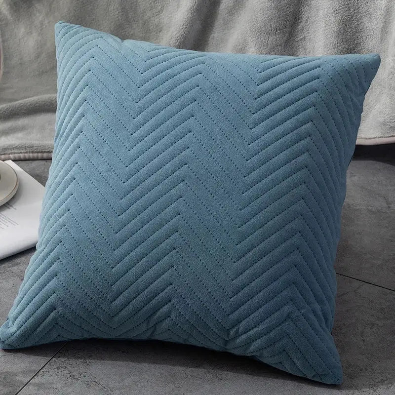 A soft teal cushion cover with textured chevron quilting perfect for decorbites blue wave living room decor