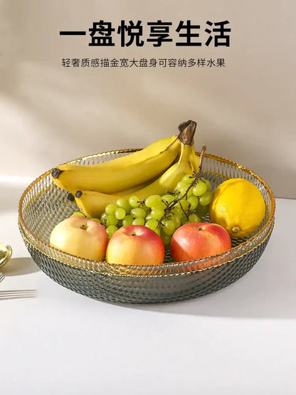 A sleek dark gray textured glass fruit plate with gold rim and woven pattern for snack storage