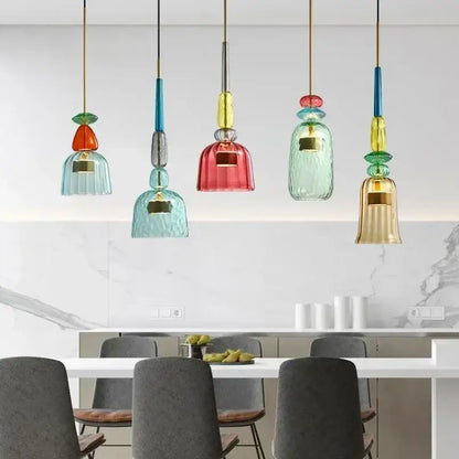 Colorful glass pendant lights with textured bell-shaped shades in teal red and gold for kitchen dining chandelier