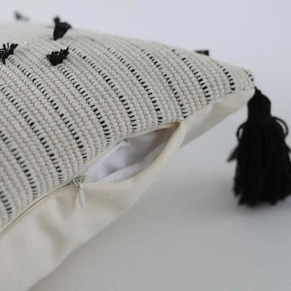 Off-white woven cushion cover with black geometric tassels and striped pattern for living room decorbites geometric tassels