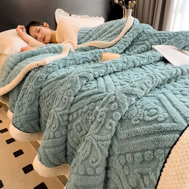 A teal coral fleece warm blanket with raised geometric texture and cream inner lining for cozy decorbites use