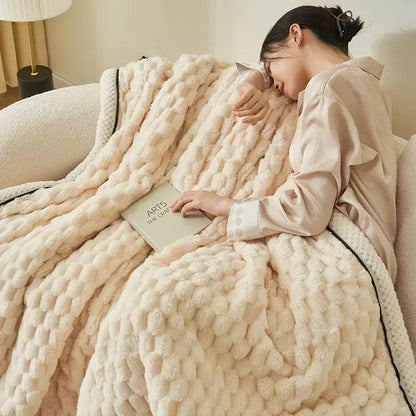 Cream-colored chunky knit throw blanket with black trim made of warm coral fleece by decorbites for bedroom use