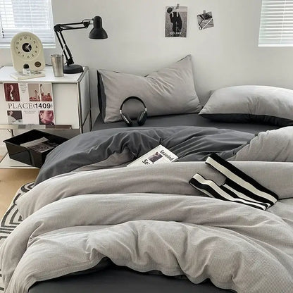 Textured dark gray and light gray bubble cotton quilt set with black and white striped accent pillow for bedroom use