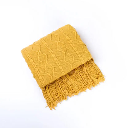Cozy knit throw blanket in mustard yellow with textured diamond pattern and tassels for decorbites cozy knit living room decor