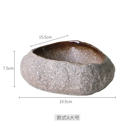 A rustic handcrafted decorbites ceramic dessert planter with textured gray exterior and glossy brown interior for dining room