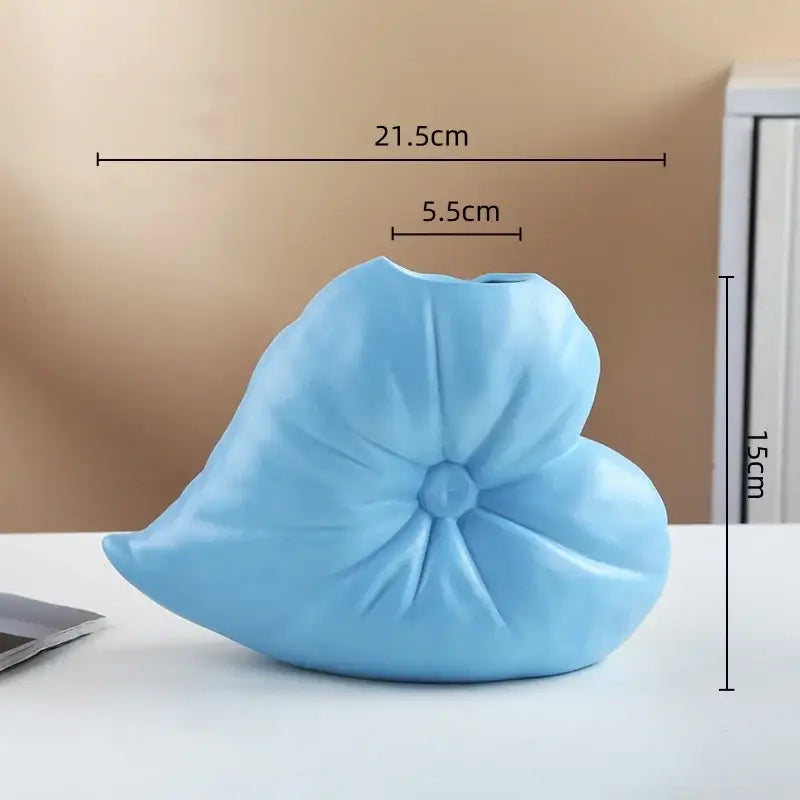 A light blue ceramic fluffy heart vase with rounded petals and central texture for decorbites living room decor