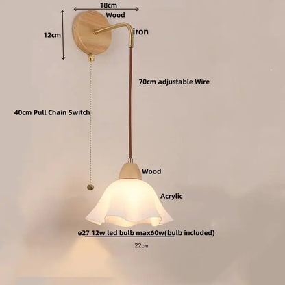 A warm-toned wall light fixture with brass iron arm, wooden base, and acrylic bell shade for dining room use