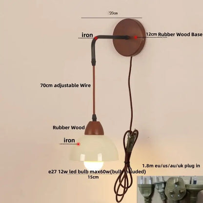 A rustic decorbites adjustable led wall light with warm rubber wood base, iron arm, and frosted textured glass shade