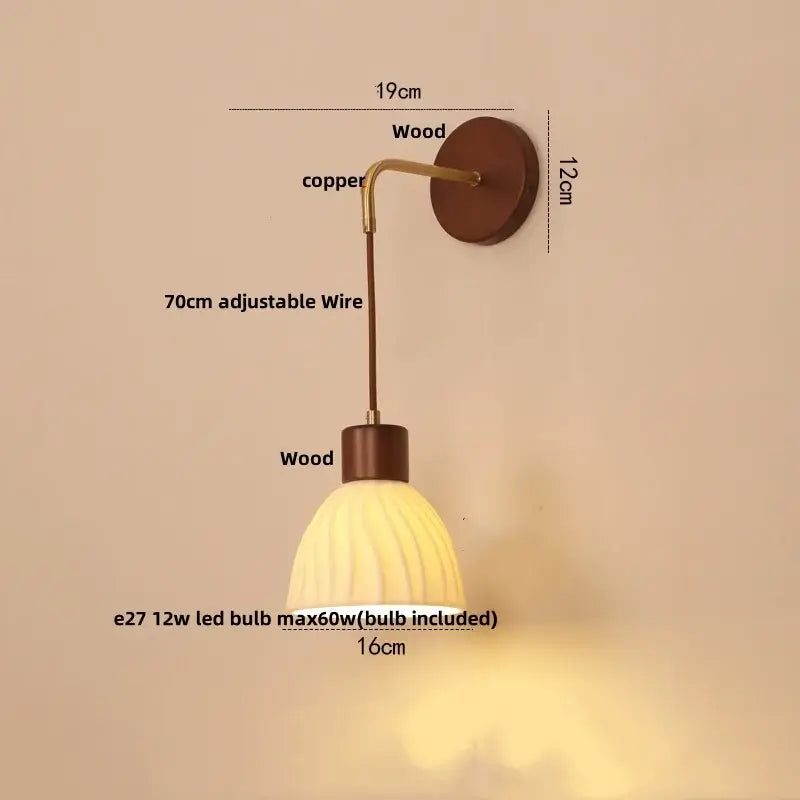 A warm-toned textured glass and wood decorbites adjustable led wall light with ribbed shade and copper arm mounted on wood