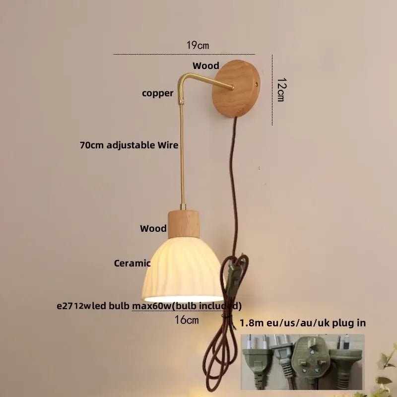 A warm-toned ceramic lampshade with ribbed texture on a brass wire arm mounted on wood for decorbites adjustable led wall light