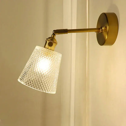A brass mirror wall sconce with a textured clear glass shade is an elegant decorbites brass mirror for bedroom use