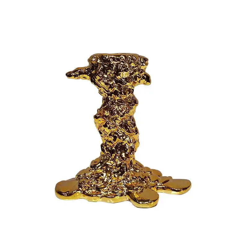 Golden candlestick holder with textured solidified metal mass design and reflective surfaces for dining room decorbites centerpiece