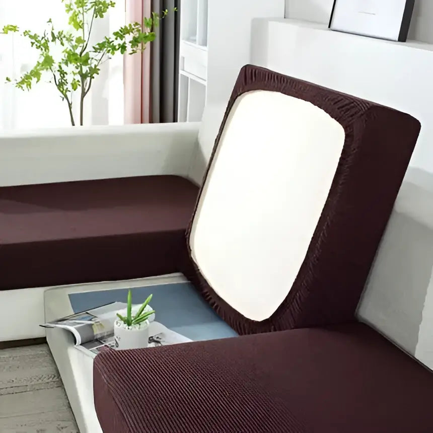 Brown stretchy fabric sofa cover with white rectangular panel on backrest for living room furniture protection