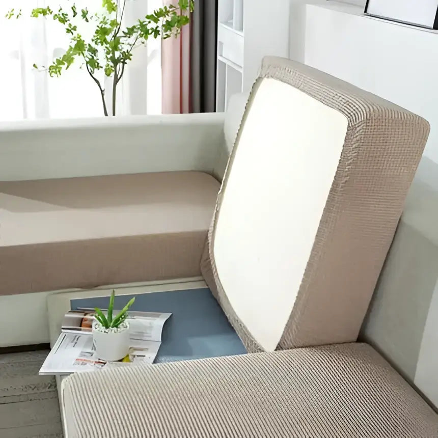 Beige textured fabric sofa cover with white backrest panel designed as a living room furniture protector