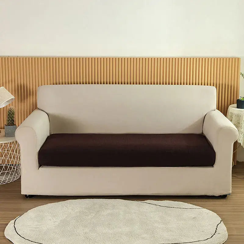 Cream-colored stretch sofa cover with contrasting dark brown seat cushion for living room textured green slipcover