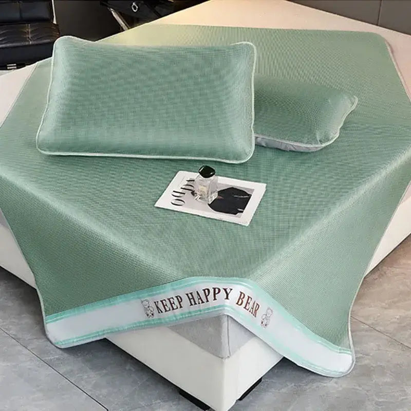 Mint green textured cooling bed mat with white trim and keep happy bear embroidery in 1800d cooling fibres pillowcases set