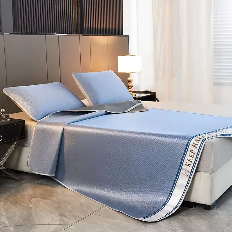 Textured light blue bed mat and pillowcases set with 1800d cooling fibres and white trim featuring keep h text