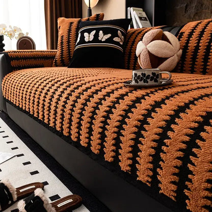 Textured olive and black striped knitted sofa cover with warm orange and black plush knit for living room slipcover