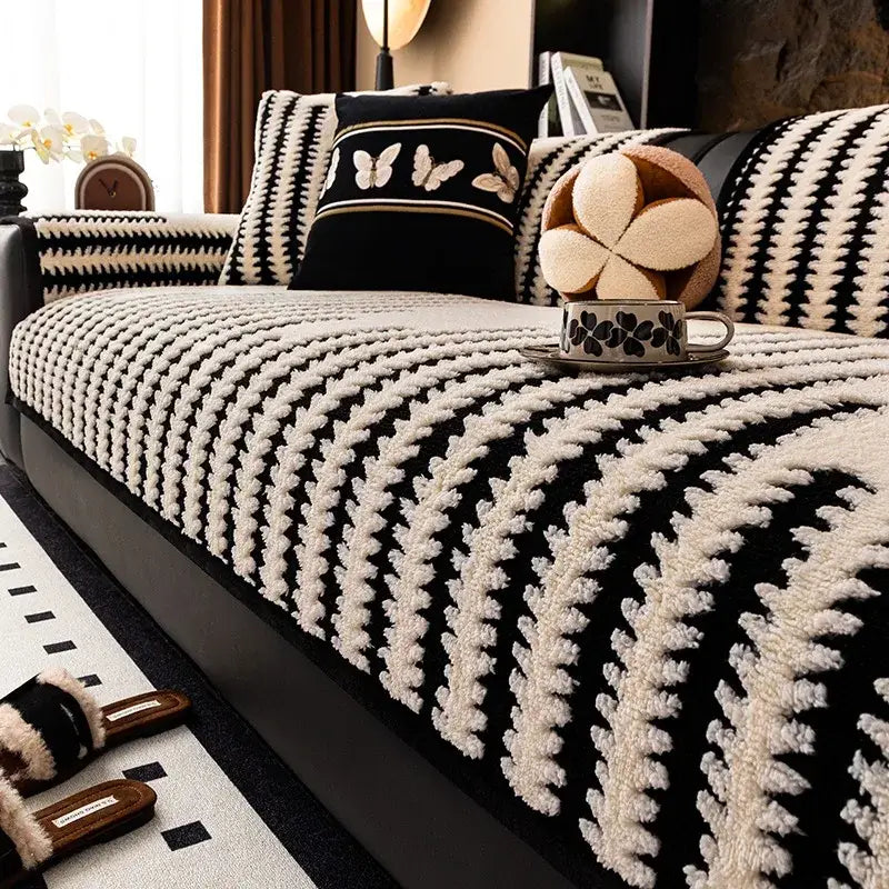 Textured olive and black striped knitted sofa cover with black and cream textured leaf pattern for living room use