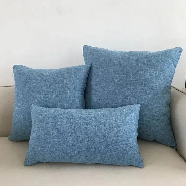 Set of three blue textured fabric throw pillows in varying sizes on beige decorbites ivory sofa cushion cover