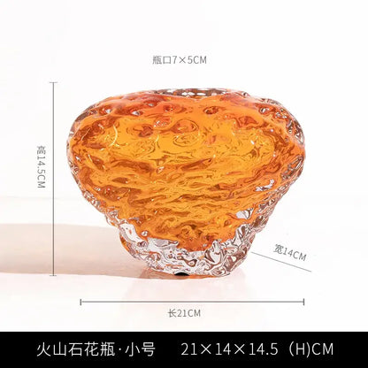 Translucent orange and yellow glass colored vase with textured organic surface and clear base for living room decor