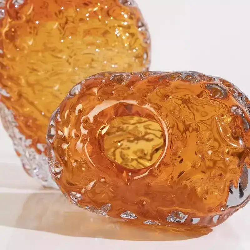 Amber-colored textured glass colored vase with swirling organic design and central circular opening for living room decor