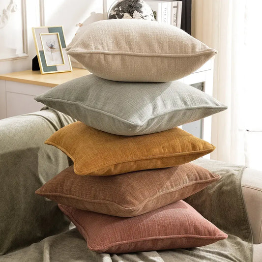 Stack of five peach and grey textured cotton linen pillow covers with visible weave and stitched edges for living room decorbites cotton linen