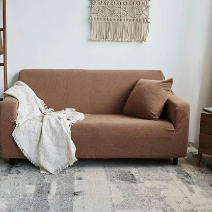 Brown textured sofa slipcover with matching pillow and white knitted throw showcasing decorbites cozy fleece sofa wrap