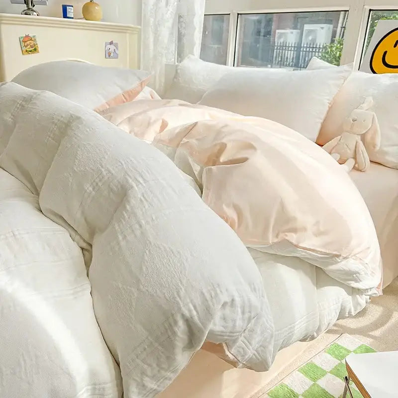 A plush off-white decorbites cotton three-layer bedding set with textured soft fabric draped over the bed