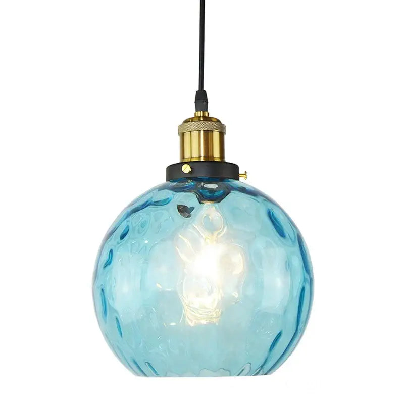 Textured turquoise blue glass ball pendant light with hammered finish and brass hardware ideal for kitchen pendant lights decorbites blue glass