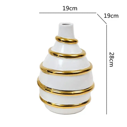 A sleek white textured decorbites golden ceramic vase with gold metallic rings for elegant living room decor