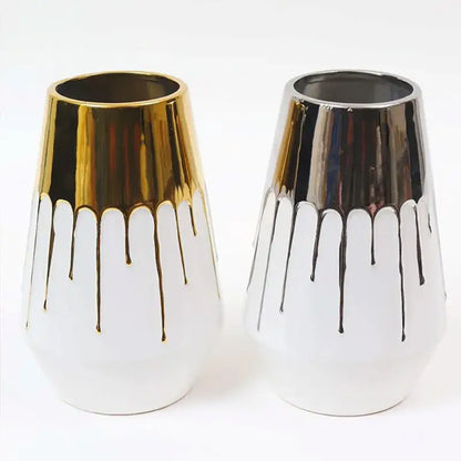 Textured white and golden ceramic vase with metallic gold and silver drips for elegant living room decor by decorbites golden